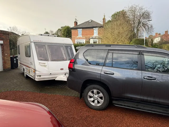 Touring caravan and tow vehicle on a driveway